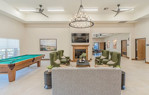 a living room with a pool table and a television